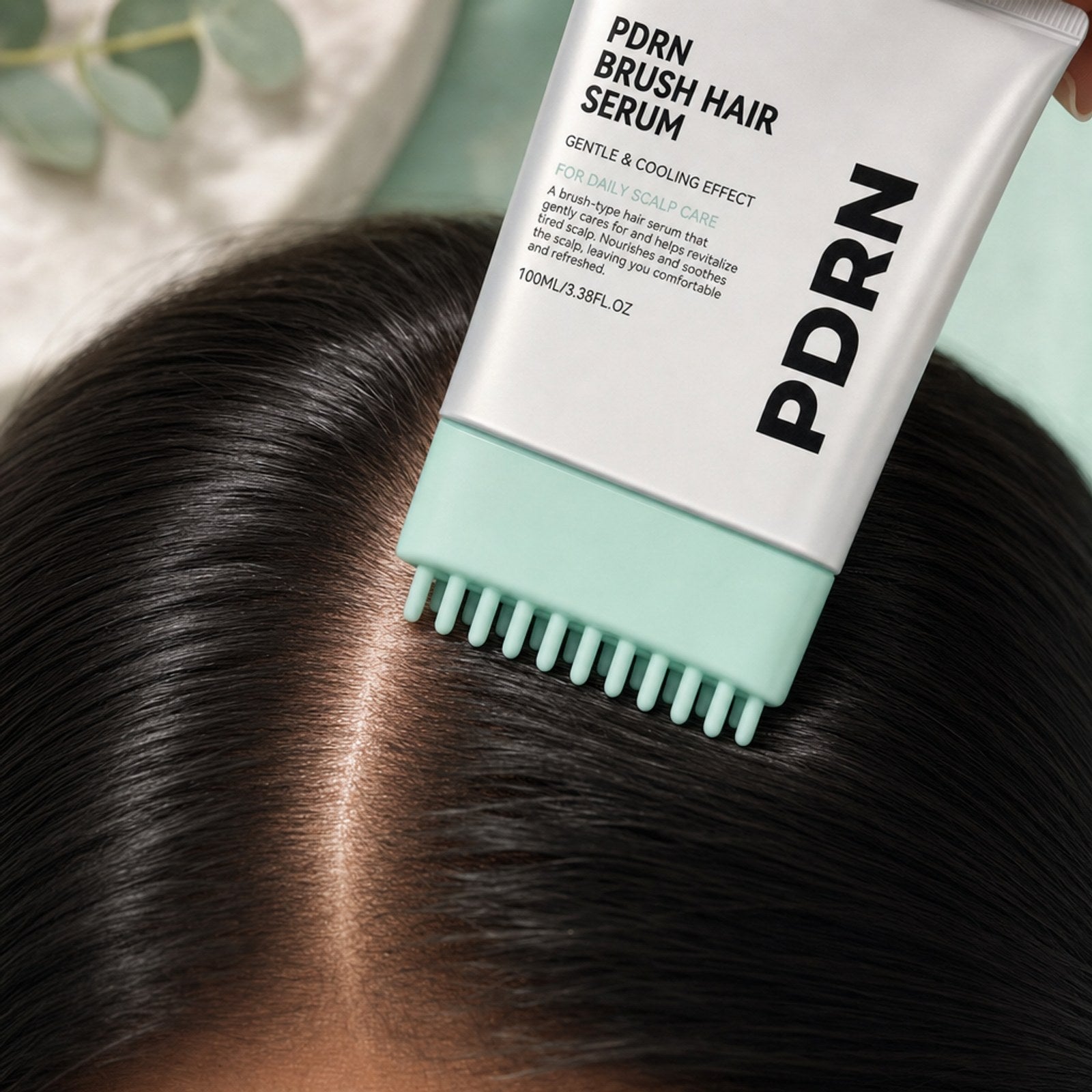 Close-up of the massage comb prongs reaching the scalp